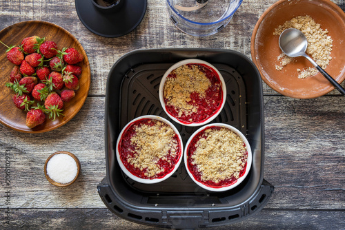 Step 8. Cooking english crumble cake with strawberry in kitchen gadget modern air fryer. Lifestyle trendy of new cooking.