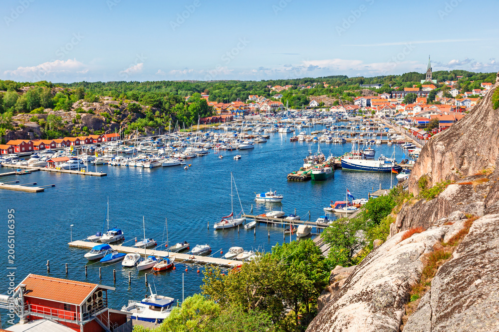 Obraz premium Scenic coastal harbor view with boats in the marina at Grebbestad a coastal village on the Swedish west coast