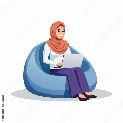 Woman in Hijab Working on Laptop While Sitting on Beanbag Chair