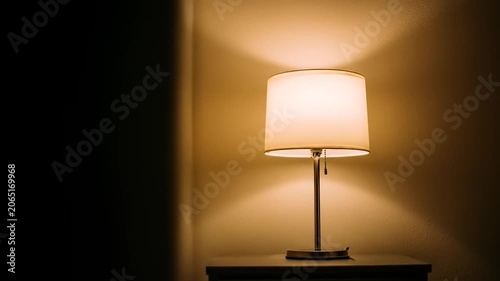Elegant table lamp illuminated on tabletop creating warm ambient light