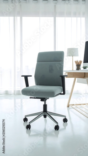 Creative design studio with a light gray ergonomic office chair featuring a soft lumbar cushion, set in an airy modern workspace. 