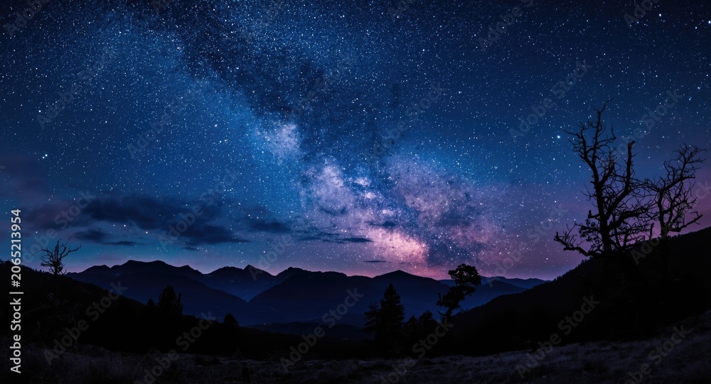 Fototapeta premium starry night mountain scene under Milky Way galaxy with long exposure effect