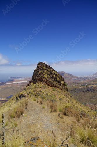 Views along the scenic hiking trail ascending from San Pedro,descending from the high threshing ground Era de Berbique toward the coastal village of Puerto de las Nieves in northwest Gran Canaria, Can