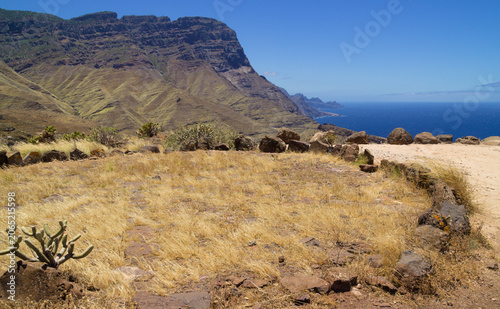 Views along the scenic hiking trail ascending from San Pedro,descending from the high threshing ground Era de Berbique toward the coastal village of Puerto de las Nieves in northwest Gran Canaria, Can