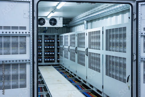 Inside a modern data center with rows of server racks and battery storage
