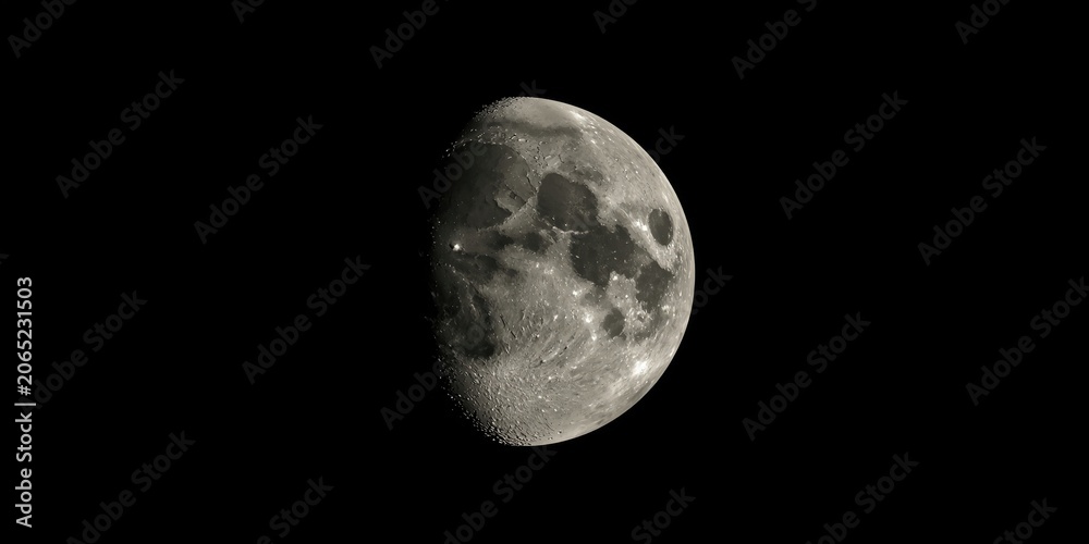 Fototapeta premium Moon surface textures visible on a smooth black background
