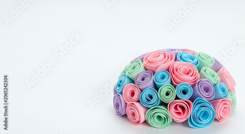 Pastel colored paper rolls arranged in a dome shape