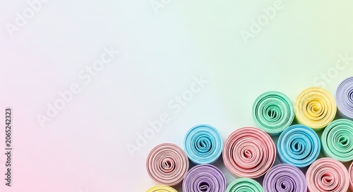 Pastel colored paper rolls arranged on a light gradient background
