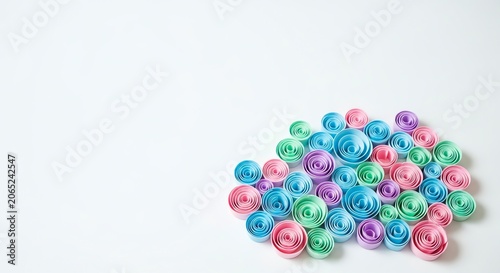 Pastel paper swirls clustered on a white background