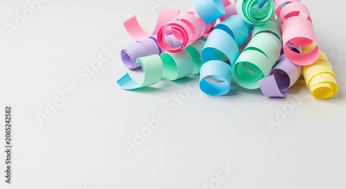 Pastel paper streamers rolled into curls on a white background