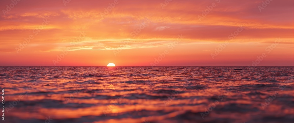 Fototapeta premium Tranquil seaside view illuminated by fiery sunset offering copy space