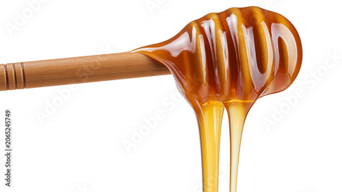 Fotografía Golden honey dripping from wooden dipper