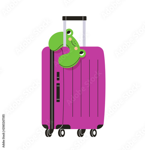 Trolley suitcase with funny frog neck pillow on grip handle. Travel baggage. ...