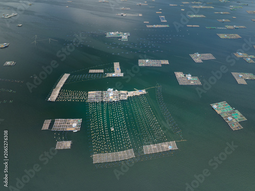 Drone photograph of offshore aquaculture facilities and floating fish cages in sheltered coastal waters near Song Cau.