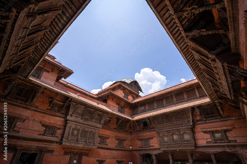 Obraz premium Ancient brick courtyards and carved wooden architecture inside Hanuman Dhoka Durbar Square in Kathmandu, Nepal