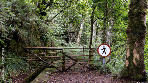 Quadro su tela A tourist route along a levada on Madeira Island, Portugal, blocked by a gate with a no entry sign