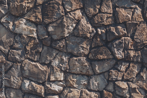 Foto Natural stone wall showcases a beautiful array of textures and colors, inviting