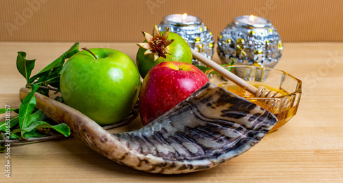 Rosh hashanah symbols with apple, honey, and shofar horn