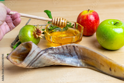 Hand dipping honey for rosh hashanah celebration