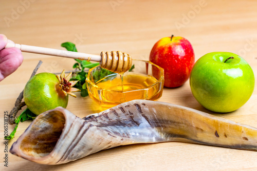 Rosh hashanah symbols with honey, apples, pomegranate, and shofar