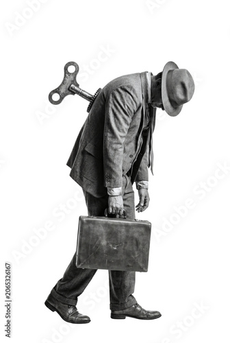 Fotografie Exhausted businessman with wind up key in his back