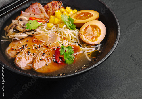 Ramen bowl with pork, noodles, corn, mushrooms, and soy eggs