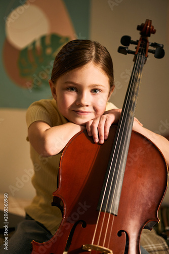 Cuadro en lienzo Portrait of Caucasian girl studying music and holding cello, showing childhood learning and creative development