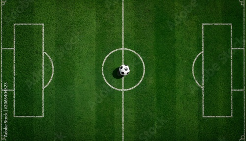Top view soccer football field template with a classic ball on the center circle line flat tactical layout of green grass pitch stadium markings and goals overhead digital illustration background