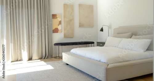 Camera panning right, revealing bedside table while bed remaining centered and sunlight narrowing