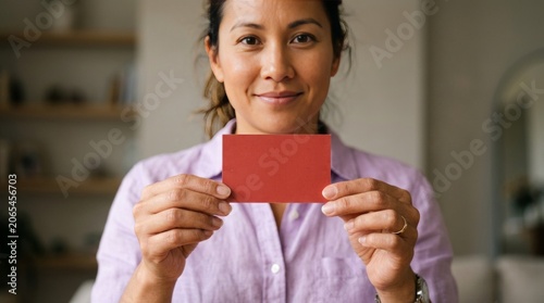 Smiling Woman Holding Red Blank Card in Hands