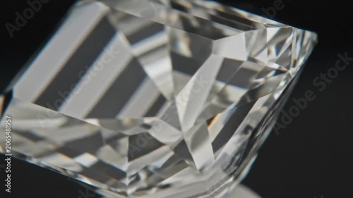 Close-up of Emerald Cut Diamond with Rainbow Refraction and Facet Reflections