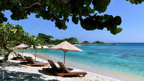 Tranquil beach with lounge chairs, umbrellas, and clear turquoise ocean