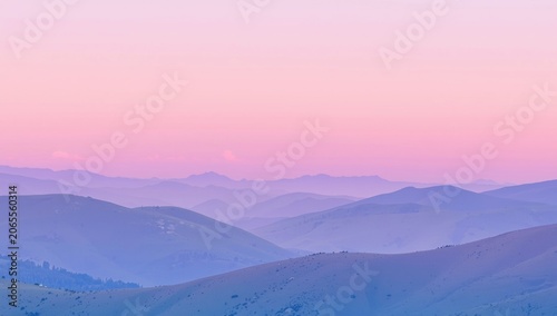 Soft pastel hues over rolling mountain hills at sunset