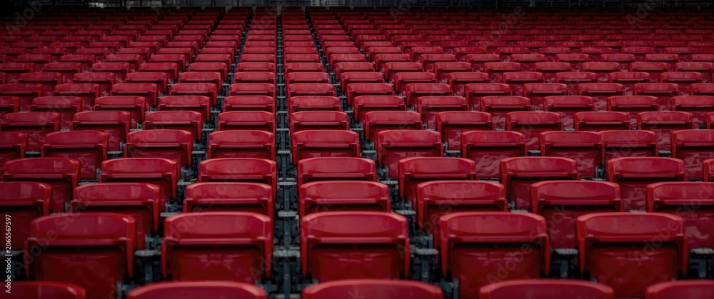 Fototapeta premium Empty rows of red stadium seats arranged in a uniform pattern