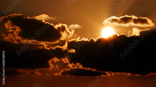 Sunset Sky with Golden Sun and Dark Clouds at Dusk Time Nature Background for Design and Advertising Purposes with Warm Lighting Effects
