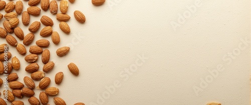 Almonds scattered on a ligh...