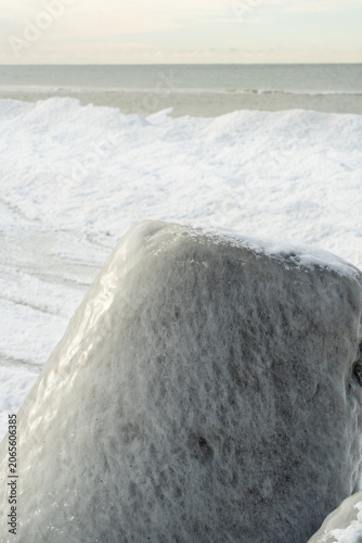 protective rocks of the breakwater covered with ice