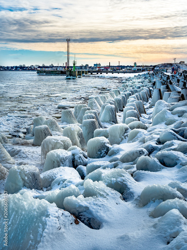 protective rocks of the breakwater covered with ice