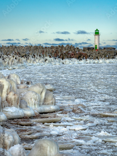 protective rocks of the breakwater covered with ice