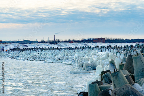 protective rocks of the breakwater covered with ice