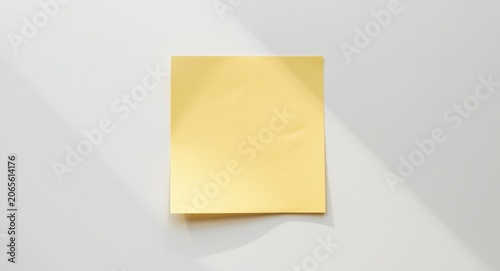 Sticky paper note placed on a clean white tabletop with copy space