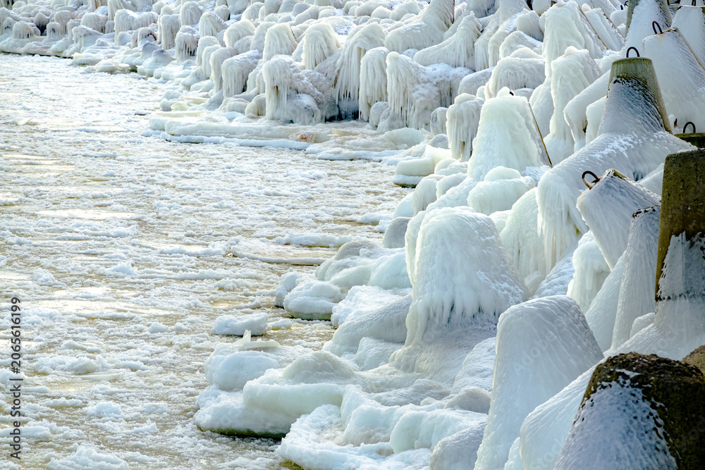 Obraz premium protective rocks of the breakwater covered with ice