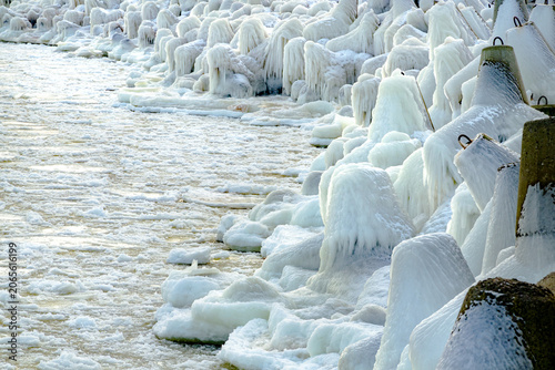 protective rocks of the breakwater covered with ice