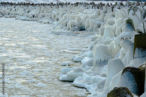 protective rocks of the breakwater covered with ice
