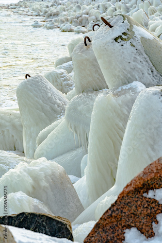 protective rocks of the breakwater covered with ice