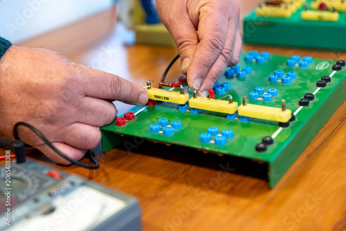 Photos Technician Hands Assembling Electronic Circuit Components on Training Breadboard