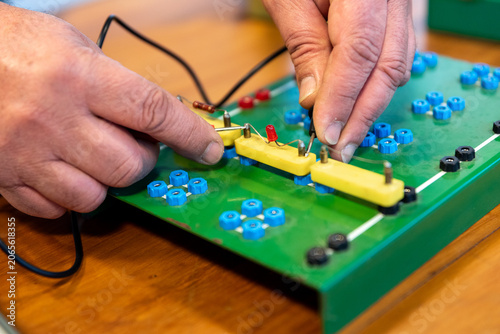 Photos Technician Hands Assembling Electronic Circuit Components on Training Breadboard