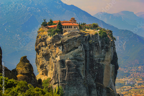 Aerial-style view of a historic Meteora monastery built on a massive rock pillar above the Thessalian plain in central Greece