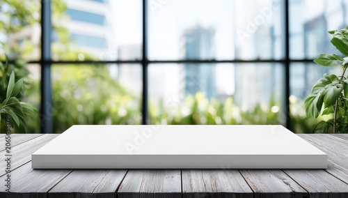 Clean White Rectangular Platform on Weathered White Wood Tabletop with Blurry Green Outdoor Plants and Modern Buildings in Background Soft Natural Light