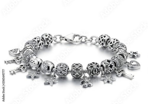 Elegant silver charm bracelet with intricate beads and dangles isolated on white background